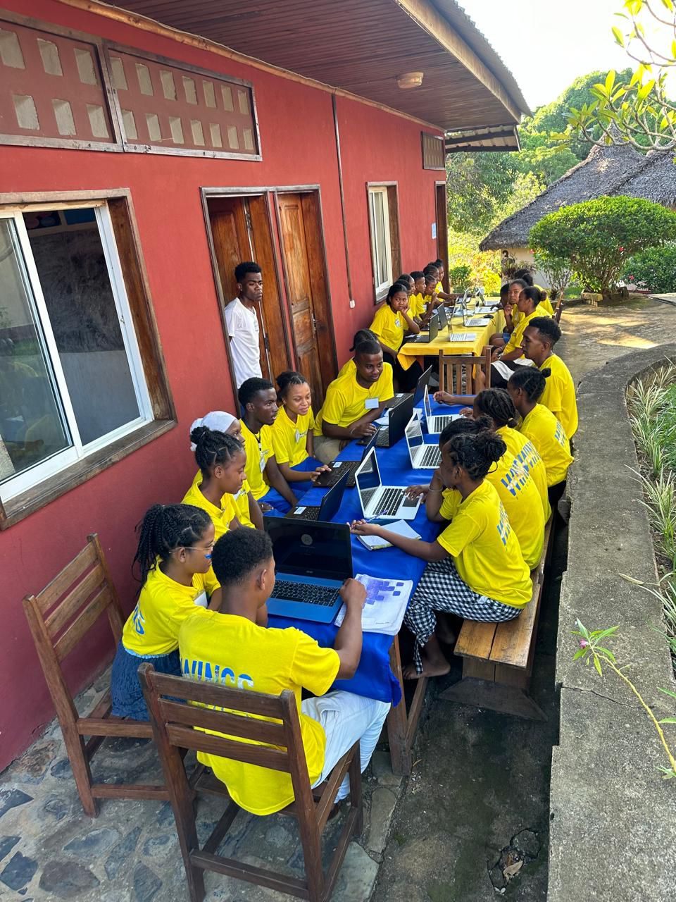 Wings of Change students in Madagascar learning on laptops during a digital program class